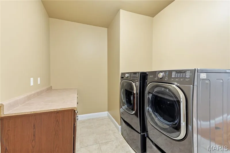 Main floor laundry room with built in cabinets — 5500 Wooded Creek Drive, O'Fallon, MO 63304