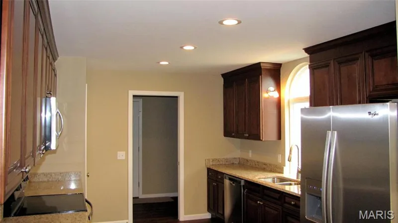 Kitchen into laundry room. — 114 Fallon Villa Court, O'Fallon, MO 63368