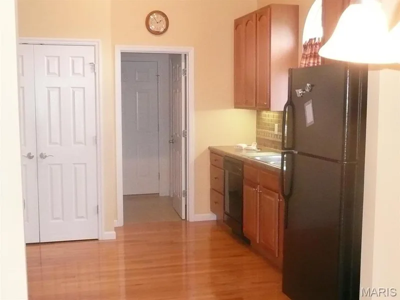 Kitchen with double door pantry, and door into laundry room and out to garage. — 118 Fallon Villa Court, O'Fallon, MO 63368