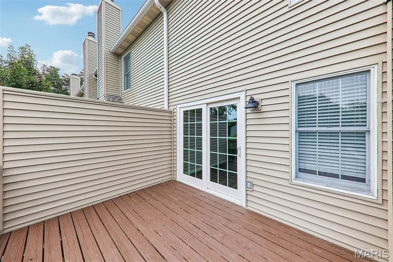 Private patio featuring a wood-finish deck and privacy wall — 16180 Lea Oak Court, Chesterfield, MO 63017