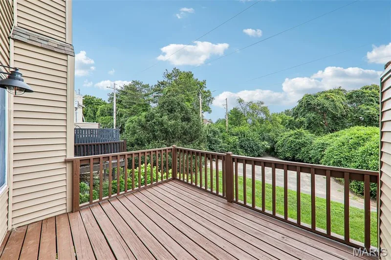 Private outdoor deck featuring wood-finish flooring and dark wood railings — 16180 Lea Oak Court, Chesterfield, MO 63017
