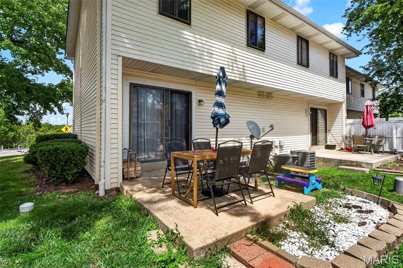 View of the Patio and Sliding Glass Door to the Dining Room — 2701 Falcons Way #132, St Charles, MO 63303