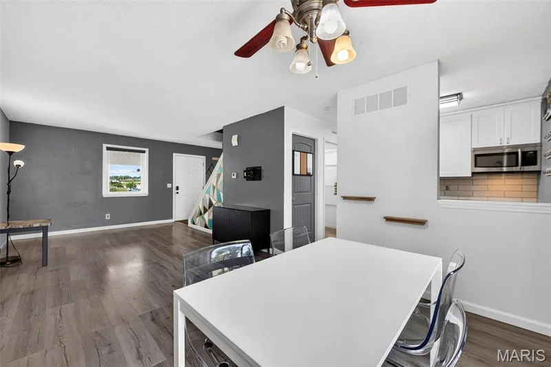 View from the Dining Room through the Living Room and Front Door, Stairway to upper level — 2701 Falcons Way #132, St Charles, MO 63303