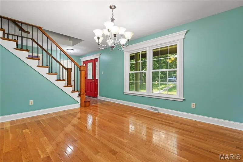 Separate Dining Room and grand staircase with wrought iron balisters — 44 Wilderness Lane, Defiance, MO 63341