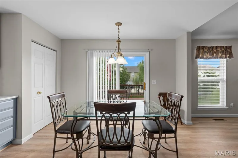 Dining kitchen combo leading to deck — 8085 Glen Arbor Drive, Lake St. Louis, MO 63367