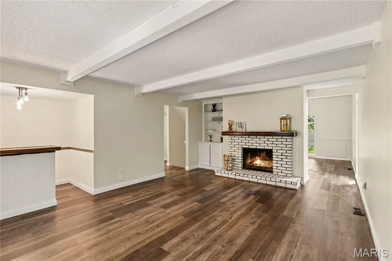 Family room w/wood-burning fireplace and built-in bookcase — 22 Normandy Drive, Lake St. Louis, MO 63367
