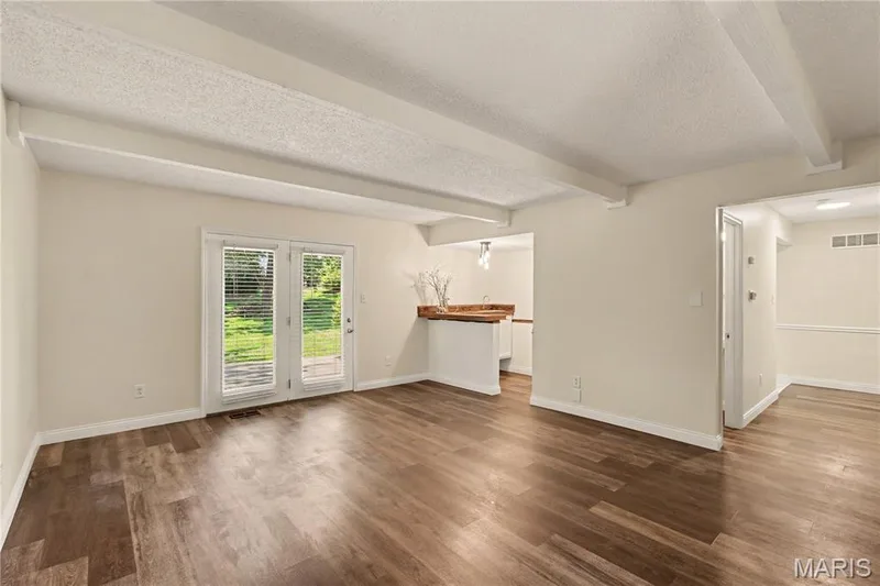 Family room w/view of dry bar and French doors leading to patio — 22 Normandy Drive, Lake St. Louis, MO 63367
