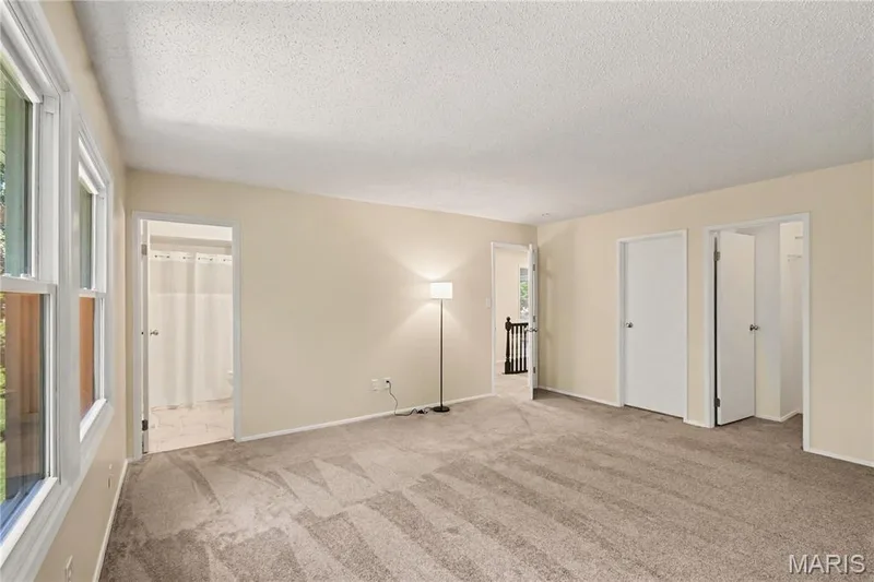 Primary bedroom w/2 walk-in closets and new carpet — 22 Normandy Drive, Lake St. Louis, MO 63367
