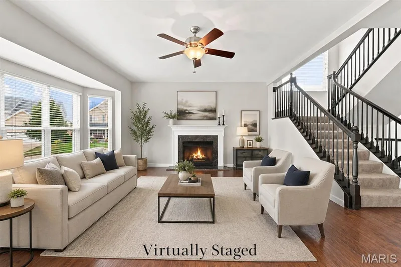 Virtually Staged for your Imagination - Open Floor Plan to Kitchen and Breakfast Area with a 6-Window Bay and a Gas Fireplace, and wood-look solid surface flooring throughout the main level. — 104 Towergate Drive, Lake St. Louis, MO 63367