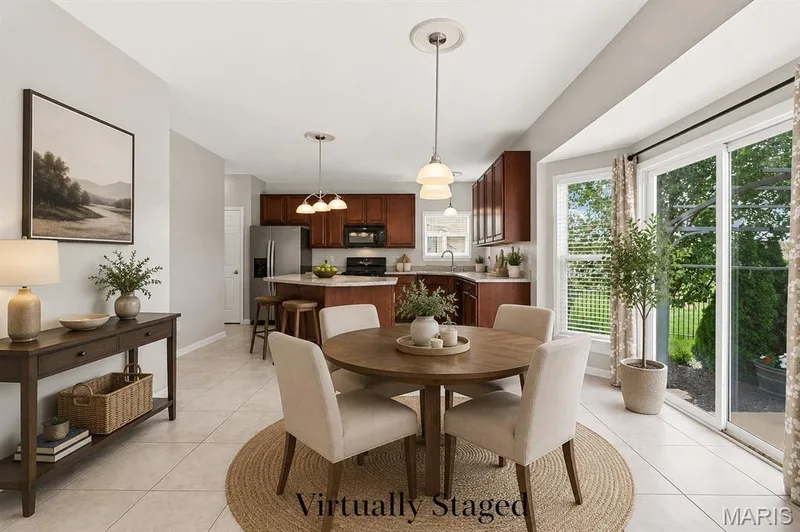 Virtually Staged Breakfast Room - Open Floor Plan from the kitchen through the dining area and into the family room with 6-Window Bay and Gas Fireplace - You'll love this floor plan! — 104 Towergate Drive, Lake St. Louis, MO 63367