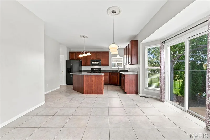 See the virtually staged picture - Open Floor Plan from the kitchen through the dining area and into the family room with 6-Window Bay and Gas Fireplace - You'll love this floor plan! — 104 Towergate Drive, Lake St. Louis, MO 63367