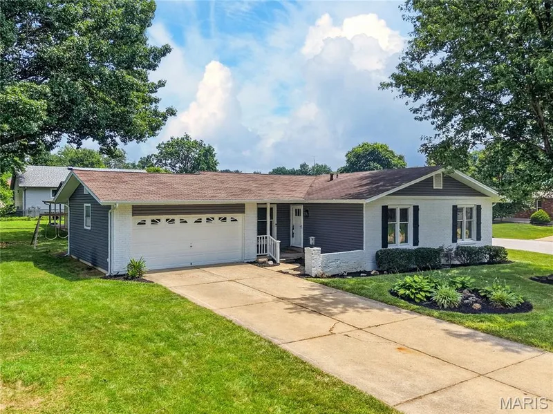 Front Elevation with Brick, Vinyl Siding, Covered Front Porch and Landscaping — 608 Mosport Drive, St Charles, MO 63304