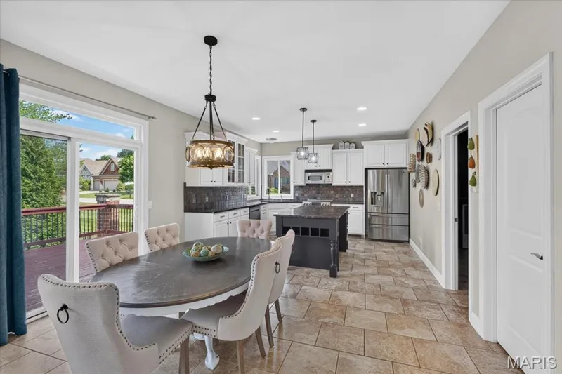The Breakfast Room has tile flooring, large walk in pantry and sliding door to the back deck. — 31 Pinewood Court, Dardenne Prairie, MO 63368