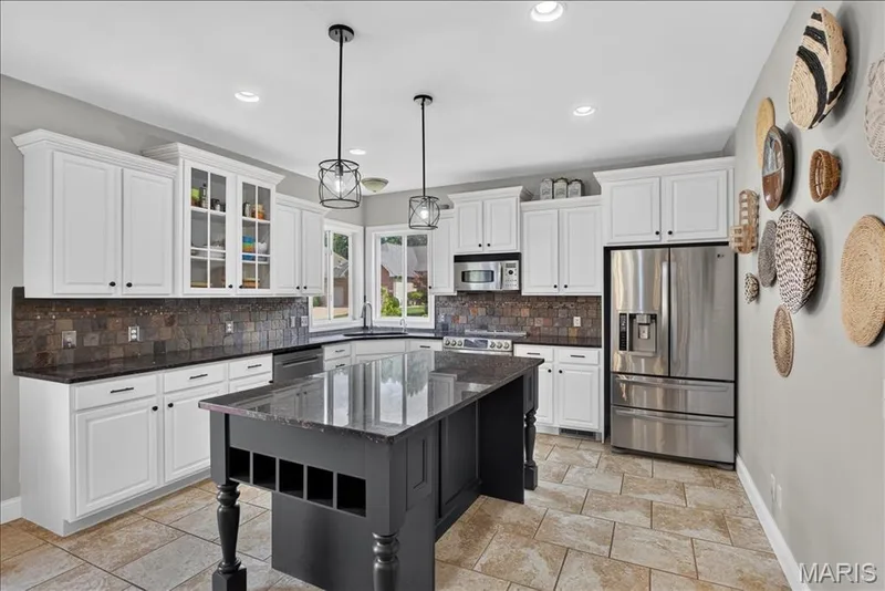 A gorgeous custom island is the centerpiece to this beautiful Kitchen. — 31 Pinewood Court, Dardenne Prairie, MO 63368