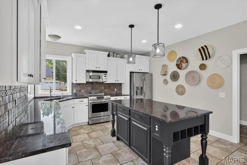 Another view of the Kitchen, with access to the main floor laundry. — 31 Pinewood Court, Dardenne Prairie, MO 63368