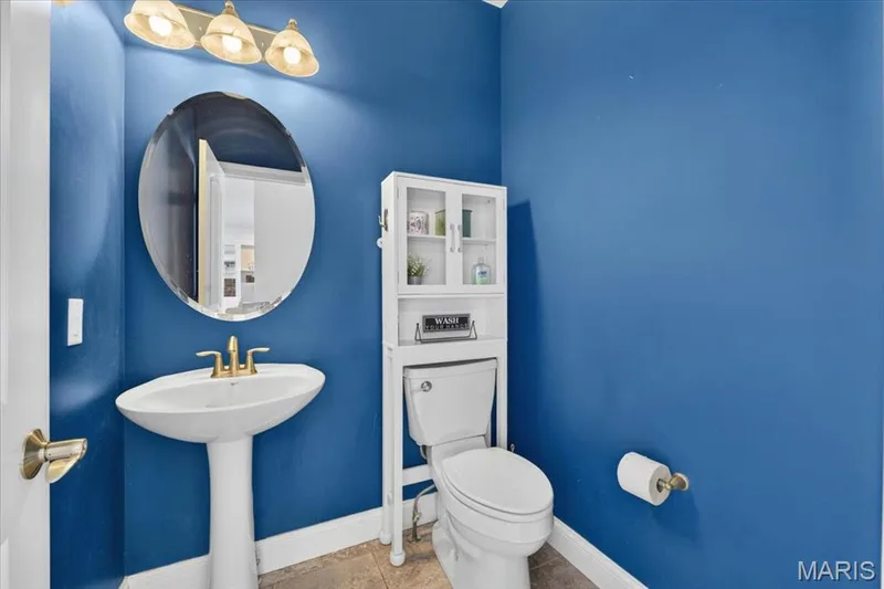 The Guest Bathroom on the main level features a pedestal sink. — 31 Pinewood Court, Dardenne Prairie, MO 63368