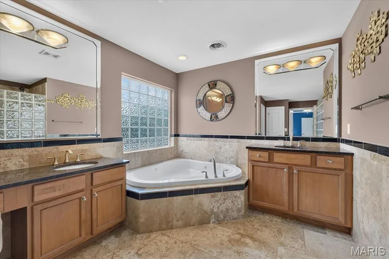 His and her vanities and a corner jet tub. — 31 Pinewood Court, Dardenne Prairie, MO 63368