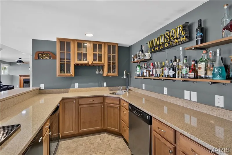 The large Lower Level walk-behind bar with wine fridge, Kegorator, dishwasher and sink — 31 Pinewood Court, Dardenne Prairie, MO 63368