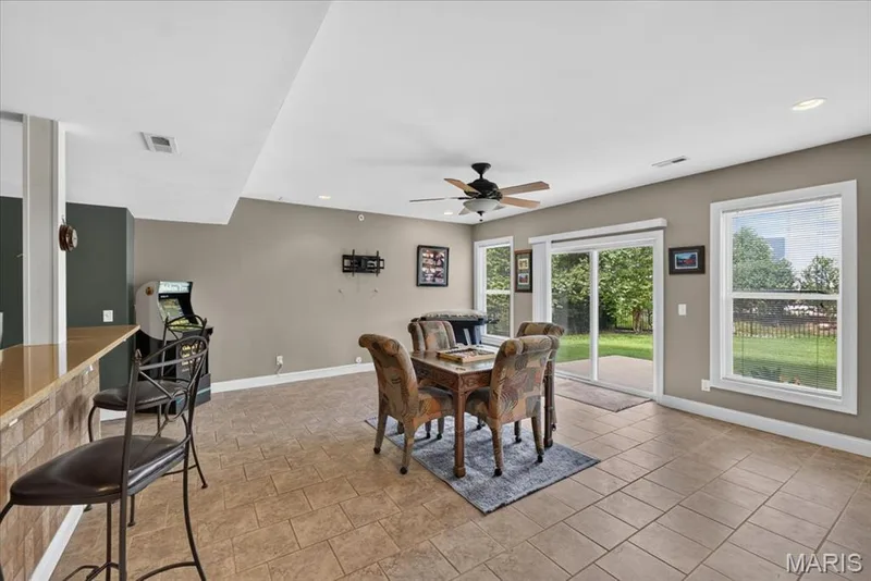 The Lower Level Game Room walks out to the fenced back yard and patio. — 31 Pinewood Court, Dardenne Prairie, MO 63368