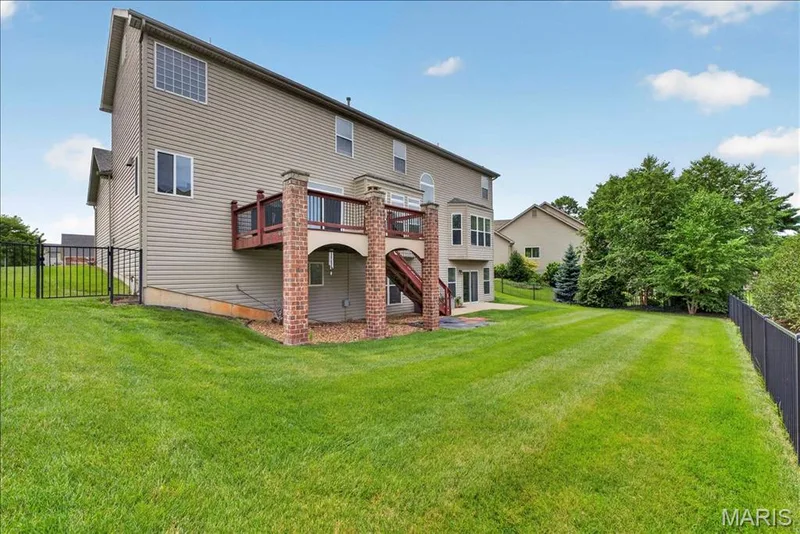 The back of the home highlighting the deck and fenced back yard. — 31 Pinewood Court, Dardenne Prairie, MO 63368