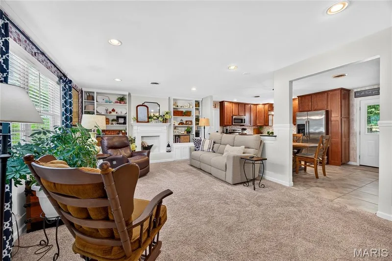 Living room with built-in shelving, a fireplace, and recessed lighting — 802 Barbara Place, O'Fallon, MO 63366