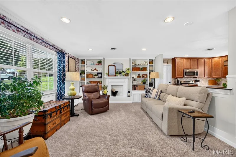 Spacious living area featuring neutral carpeting and recessed lighting — 802 Barbara Place, O'Fallon, MO 63366