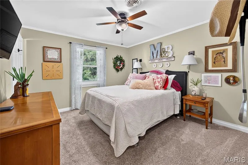Bedroom featuring neutral wall paint, a ceiling fan with integrated lighting, and carpet flooring — 802 Barbara Place, O'Fallon, MO 63366