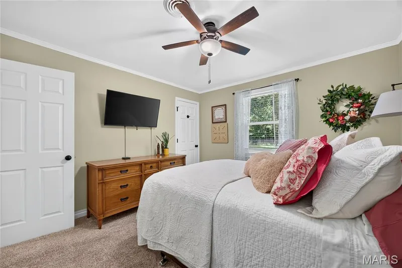 Carpeted interior space featuring light-colored walls and white trim — 802 Barbara Place, O'Fallon, MO 63366