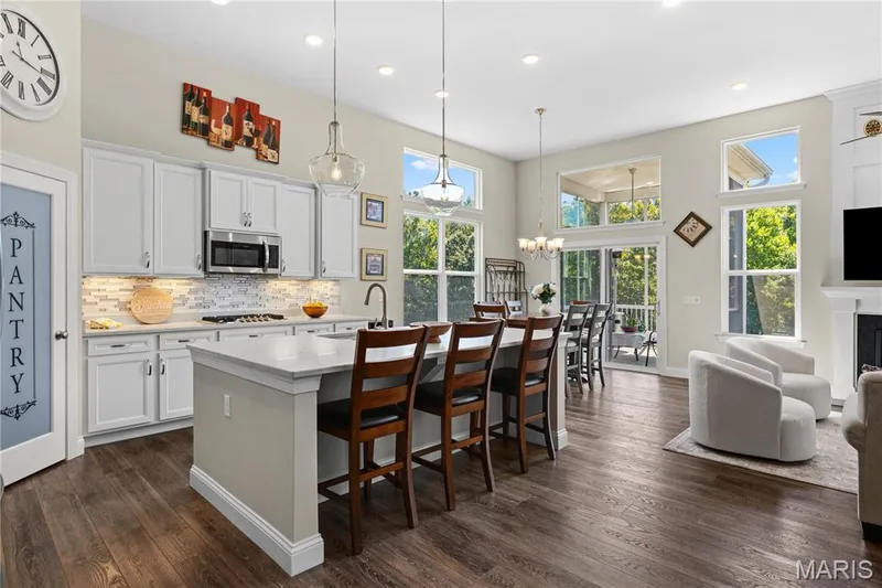 Quartz countertops, 42-inch white cabinetry and  abundant natural light. — 1316 Silver Fern Drive, Lake St. Louis, MO 63367