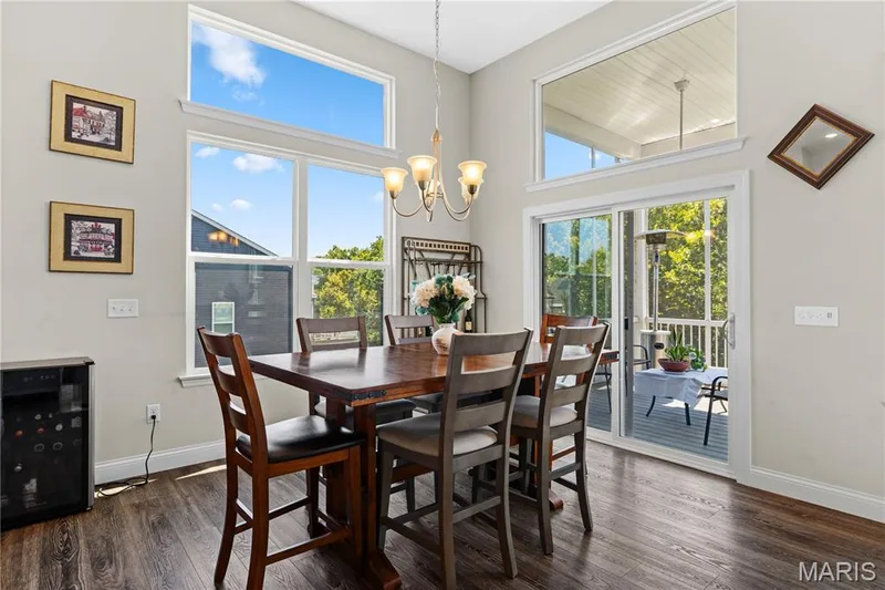 From the dining area,  sliding doors open to the screened deck. — 1316 Silver Fern Drive, Lake St. Louis, MO 63367