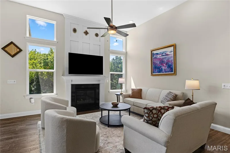 This great room - living area features the gas fireplace for cozy gatherings in cooler weather. — 1316 Silver Fern Drive, Lake St. Louis, MO 63367