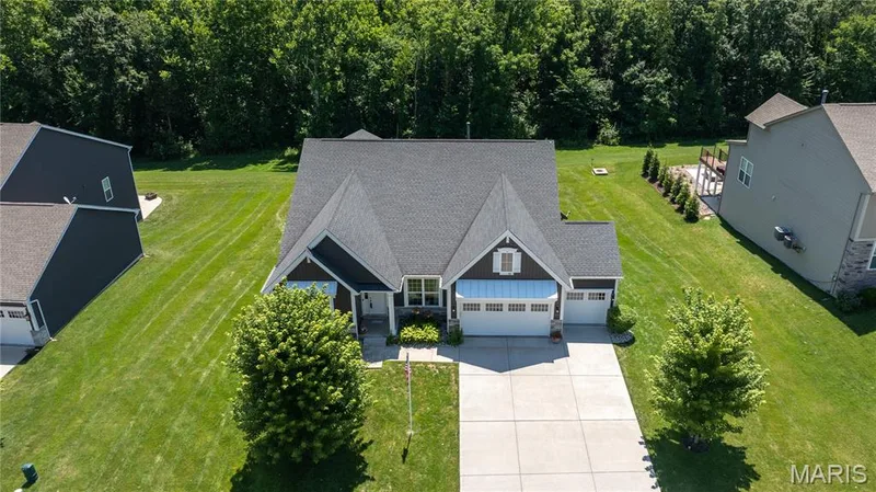The backyard slopes toward the wooded acreage of Deer Ridge Nature Park. — 1316 Silver Fern Drive, Lake St. Louis, MO 63367