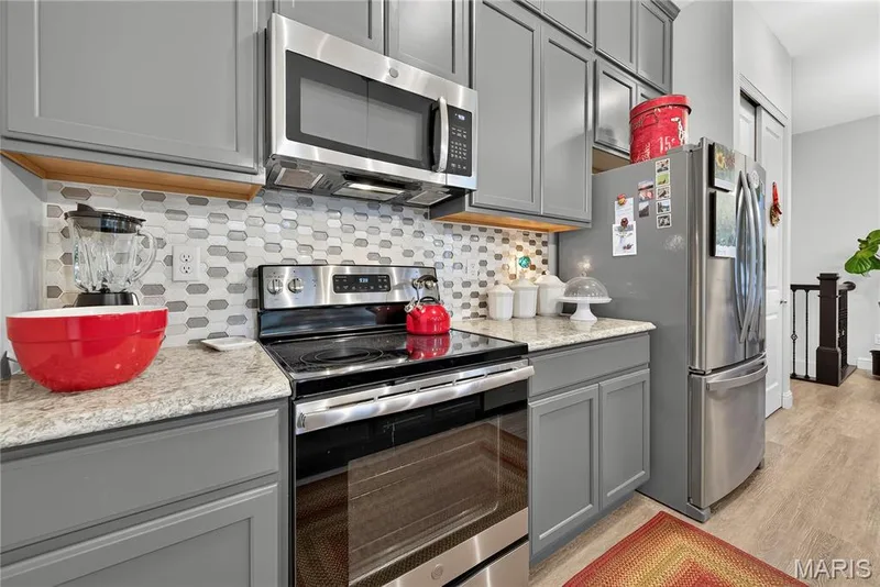 Designer Glass Tile Backsplash & Stainless Appliances- French Door Refrigerator stays! — 6170 Suntan Drive, St Charles, MO 63301