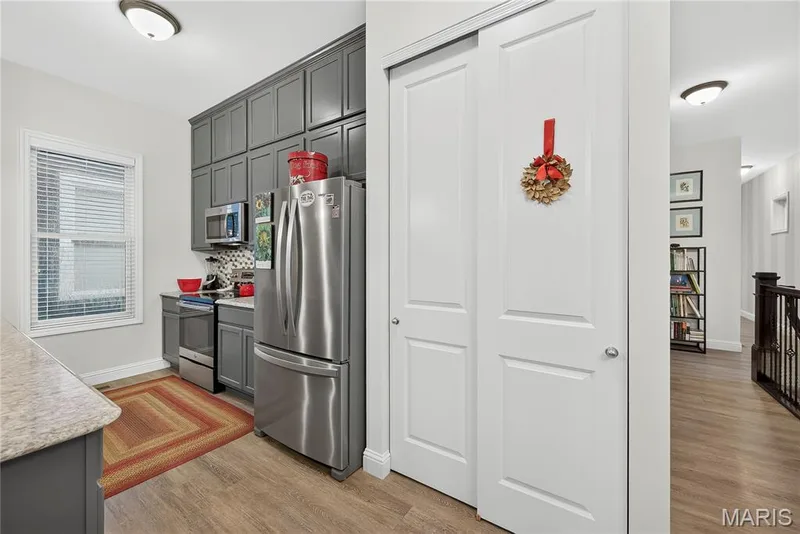 TONS of Storage! The DRAMATIC Cabinetry Wall with 42" Upper Cabinets and the Designer Top Cabinets!  Full-Size Pantry too! — 6170 Suntan Drive, St Charles, MO 63301