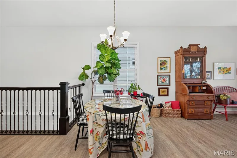 The Open Wood Newel Square Post & Bird Cage Spindles really enhance the OPEN FEEL of the Main Floor! — 6170 Suntan Drive, St Charles, MO 63301