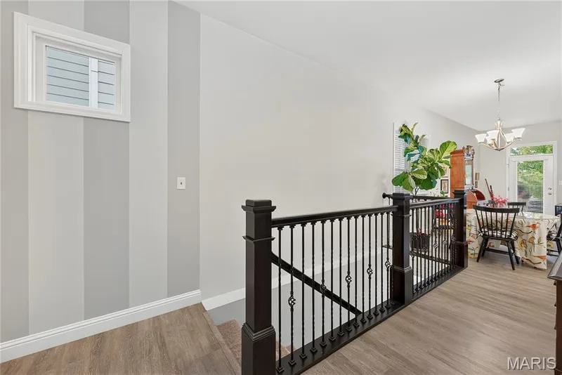 Open Stairs to the Lower Level with Egress Window & Rough-In Plumbing ready for your Finish! Notice the Hallway with Designer Paint & Charming Transom Windows! — 6170 Suntan Drive, St Charles, MO 63301