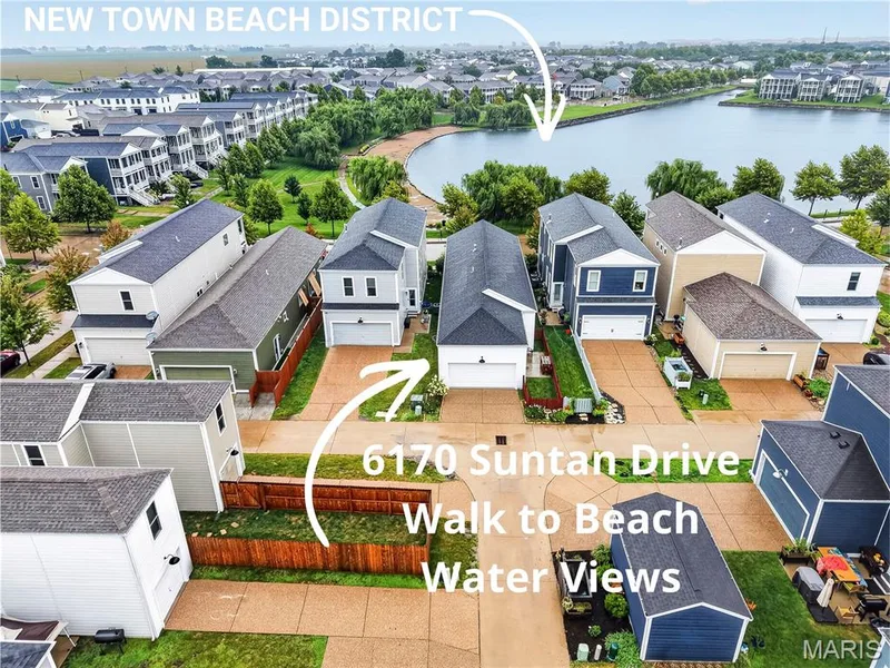 This home has beautiful views of one of New Town's Lakes & Canals- and this home is located directly in the BEACH DISTRICT! — 6170 Suntan Drive, St Charles, MO 63301