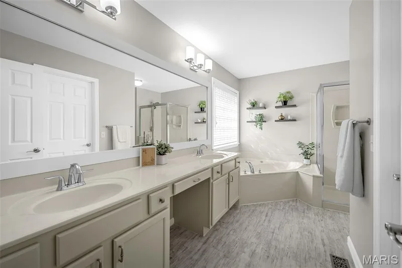 Primary bathroom with double bowl vanity, tub and separate shower. Nice size walk-in closet also. — 3416 Sun Bear Court #830C, Wentzville, MO 63385