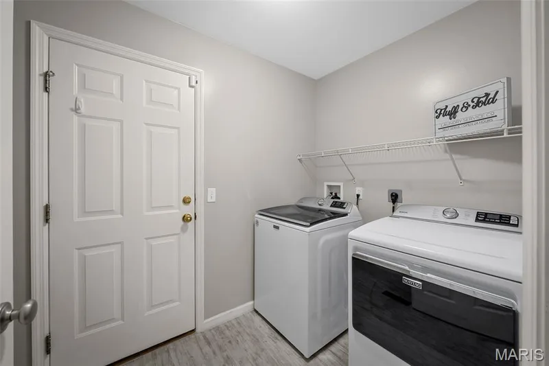 Main floor laundry room with door to garage. — 3416 Sun Bear Court #830C, Wentzville, MO 63385