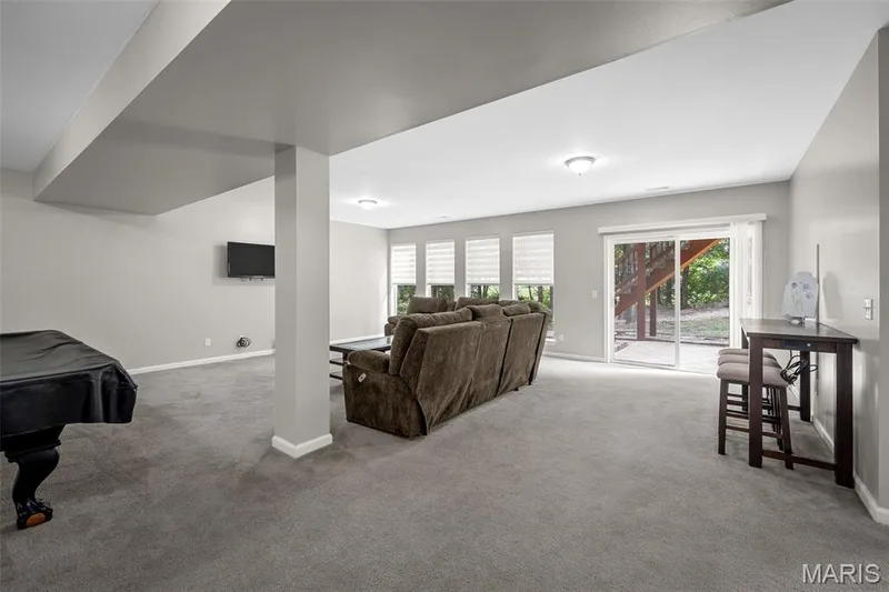 Family room with wall of windows and slider to backyard. — 3416 Sun Bear Court #830C, Wentzville, MO 63385