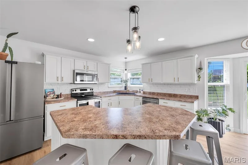 Ample island for additional counter space — 202 Wyndtrace Court, Lake St. Louis, MO 63367