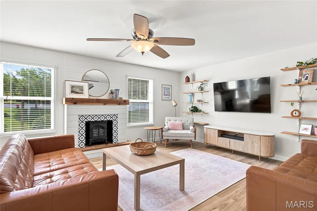 Sunny living room with built-ins and newer floors — 202 Wyndtrace Court, Lake St. Louis, MO 63367