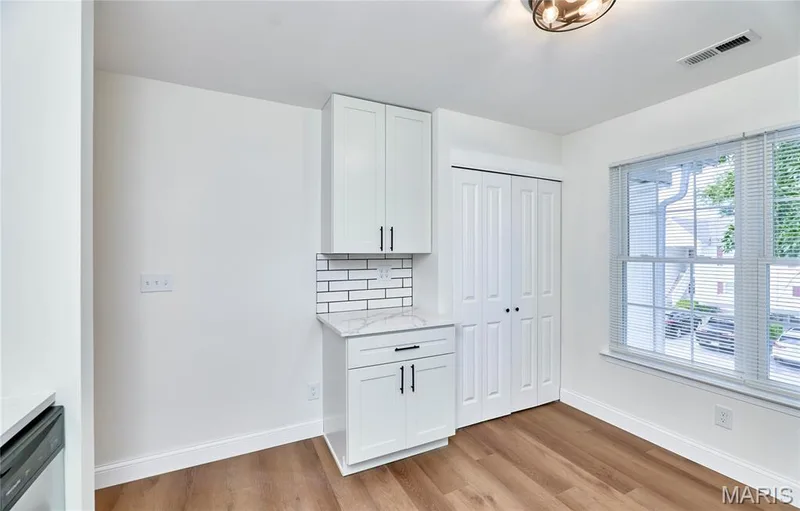 Modern kitchen featuring white shaker-style cabinetry with matte black hardware — 214 Sugar Lake Drive #5, St Peters, MO 63376