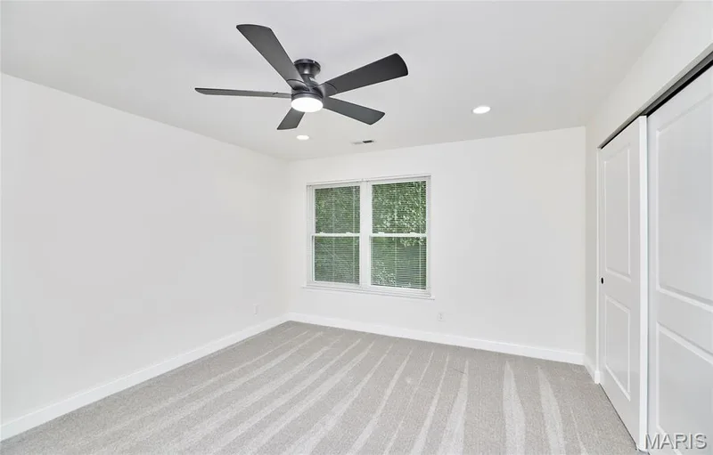 Bedroom featuring a ceiling fan, recessed lighting, white walls, and light-toned carpet — 214 Sugar Lake Drive #5, St Peters, MO 63376