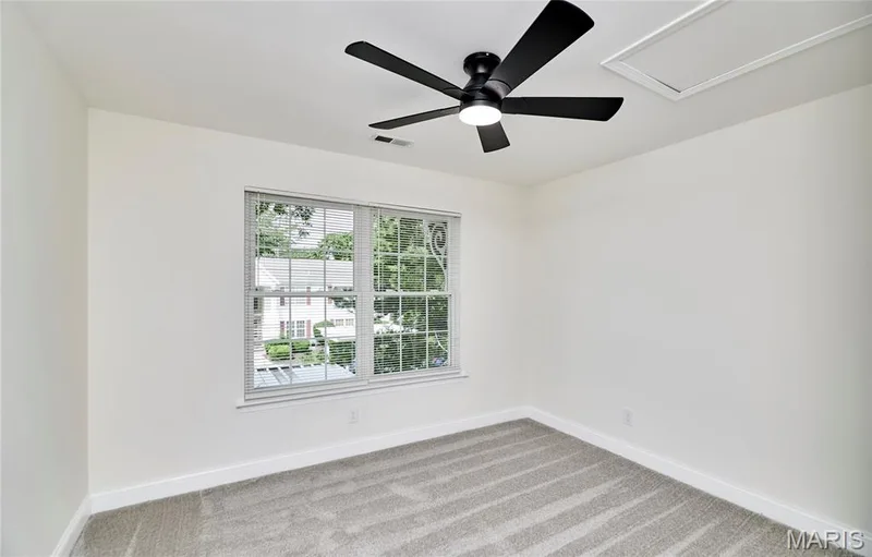 Neutral tone wall paint with a contemporary ceiling fan featuring integrated lighting — 214 Sugar Lake Drive #5, St Peters, MO 63376