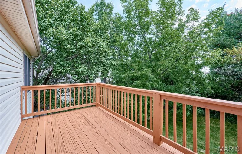 Wood deck with a painted railing and balusters — 214 Sugar Lake Drive #5, St Peters, MO 63376