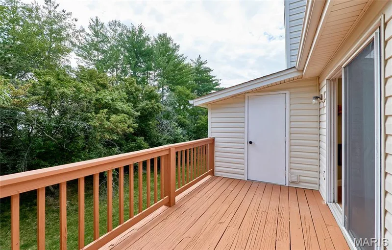Wood deck with a painted railing and balusters — 214 Sugar Lake Drive #5, St Peters, MO 63376