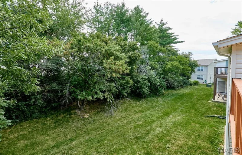 Spacious grass yard bordered by mature trees — 214 Sugar Lake Drive #5, St Peters, MO 63376