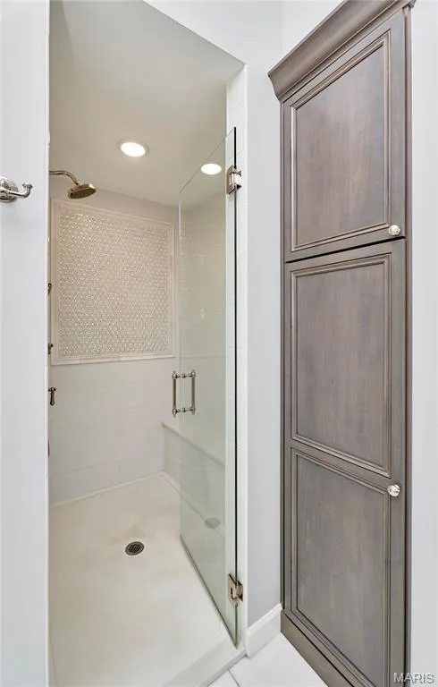 Lovely walk-in shower, large seat, recessed lighting and adjacent to handy storage area. — 2323 Wellington Estates Drive, Chesterfield, MO 63017