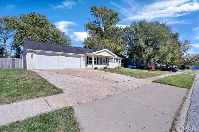 Single-story residence featuring light-colored siding, an attached two-car garage, and a covered front entryway — 503 Eggering Drive, O'Fallon, MO 63366